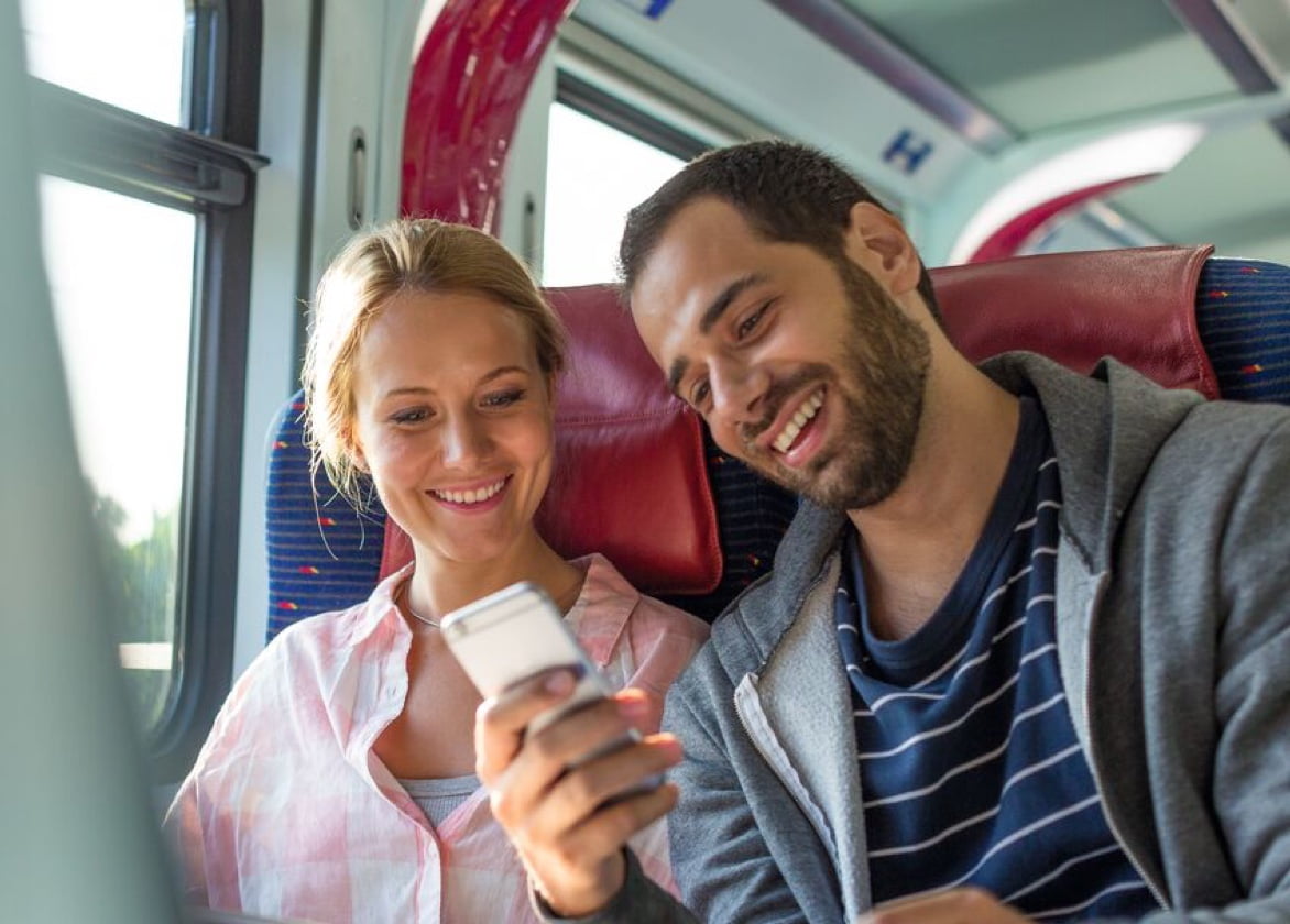 Man and woman looking at smartphone and smiling