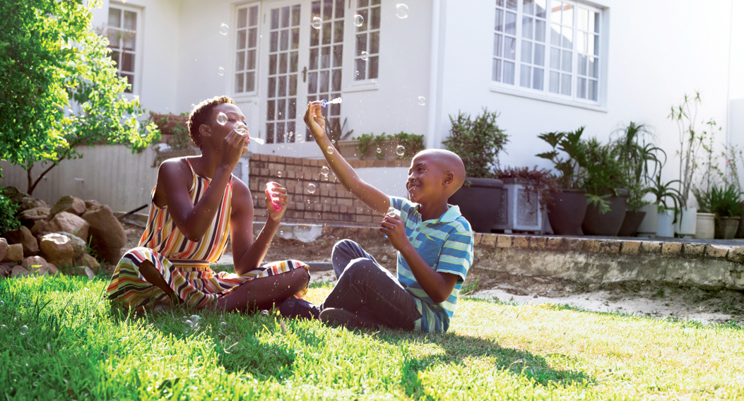 woman and child playing on lawn