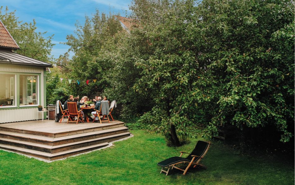 group of people gathering on a backyard deck