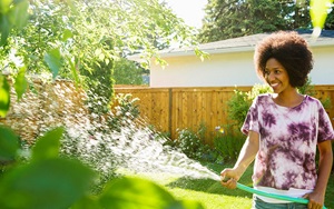 woman watering green garden
