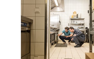 customer and applicator inspecting industrial kitchen