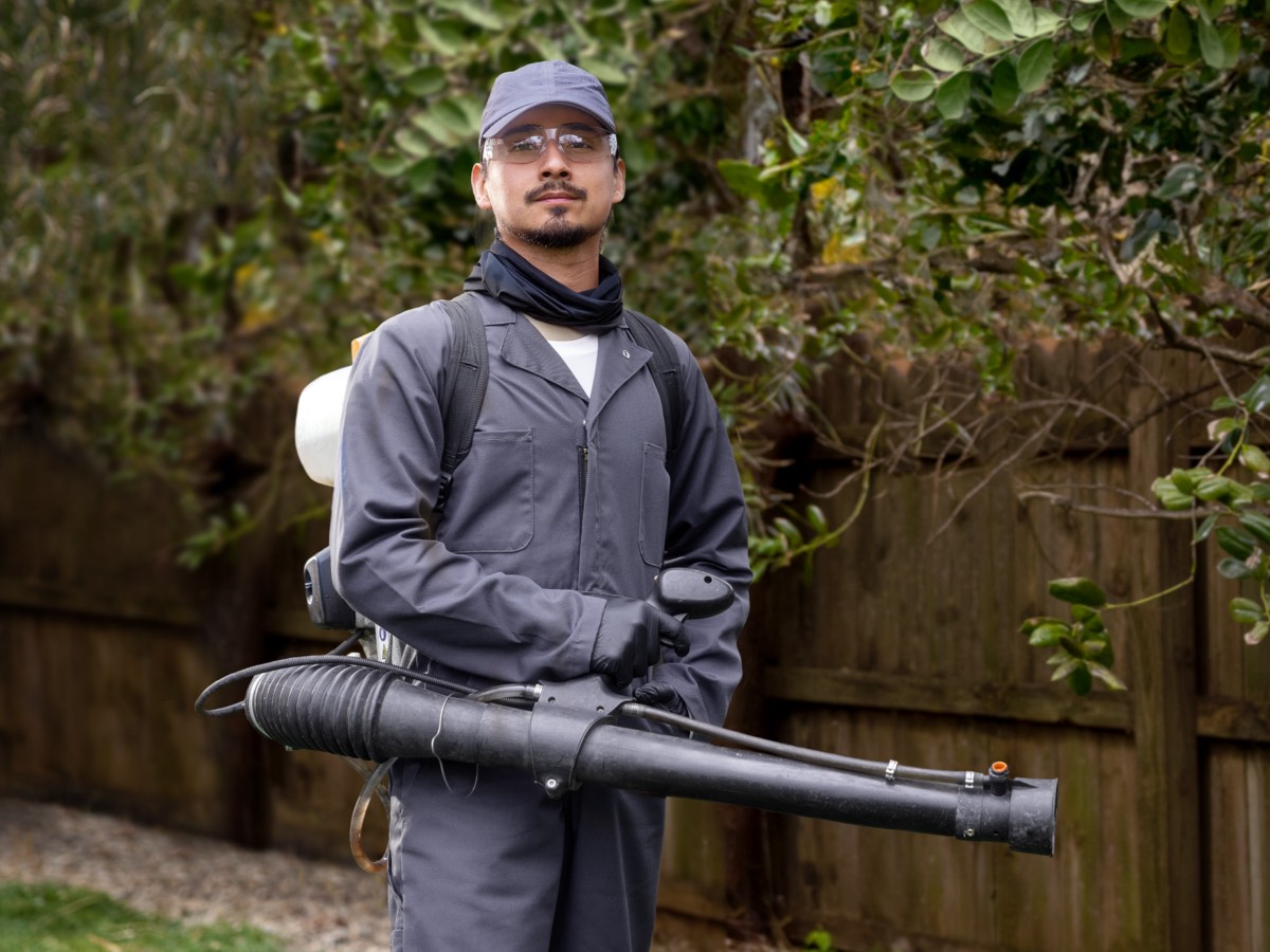 man posing with sprayer applicator