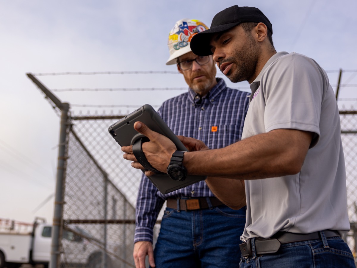 two men looking at tablet