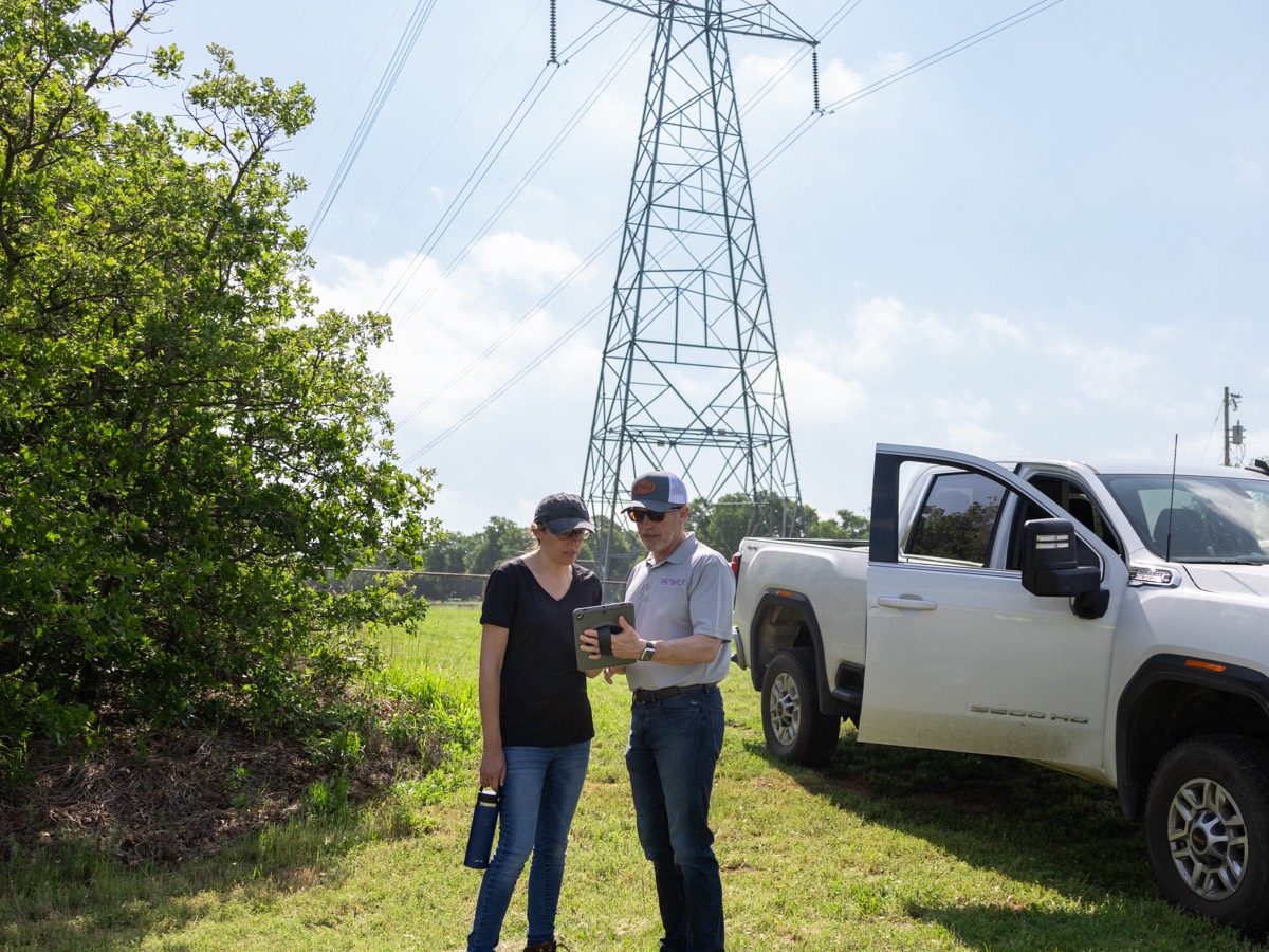 two people standing near white truck