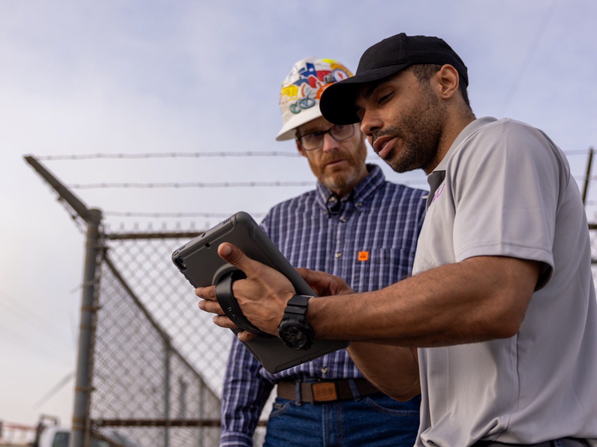two men looking at tablet